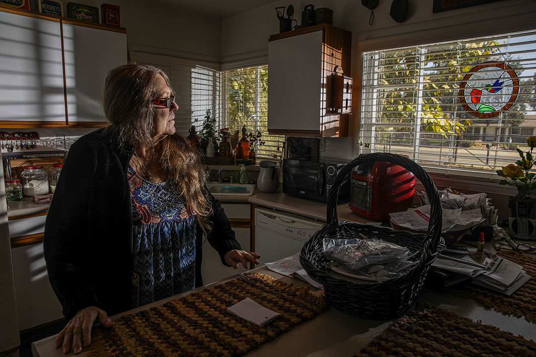 Vicki McDowell stands in her kitchen, staring outside the window.